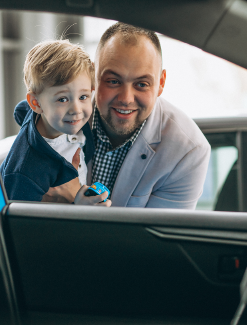 Man and Child looking inside car